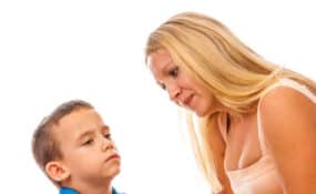 a mom with blonde hair talking to her young child